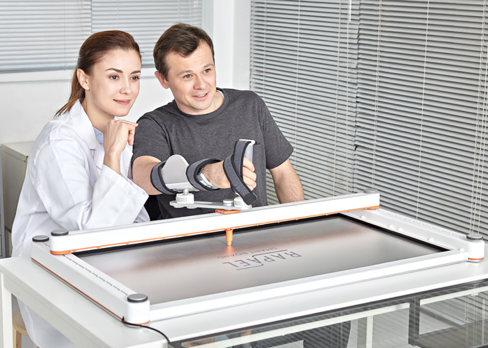 A therapist and patient immersed in the Neofect Smartboard game.
